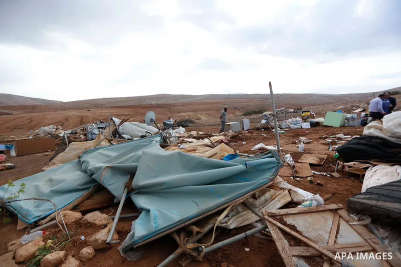 Palestinian bedouins stand next to their belongings after Israeli soldiers demolished their tents in an area east of the village of Tubas, in the West Bank, on November 3, 2020. Photo by Shadi Jarar'ah