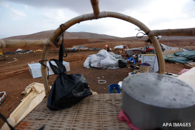Palestinian bedouins stand next to their belongings after Israeli soldiers demolished their tents in an area east of the village of Tubas, in the West Bank, on November 3, 2020. Photo by Shadi Jarar'ah