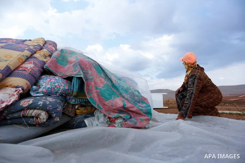 Palestinian bedouins stand next to their belongings after Israeli soldiers demolished their tents in an area east of the village of Tubas, in the West Bank, on November 3, 2020. Photo by Shadi Jarar'ah