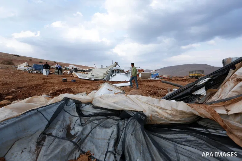 Palestinian bedouins stand next to their belongings after Israeli soldiers demolished their tents in an area east of the village of Tubas, in the West Bank, on November 3, 2020. Photo by Shadi Jarar'ah