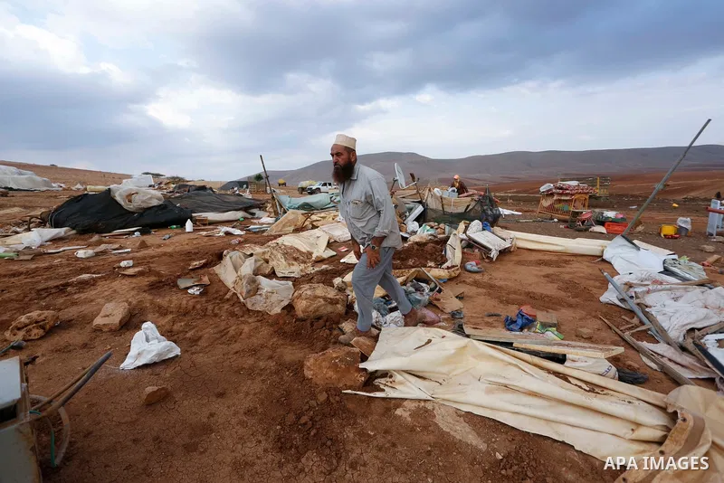 Palestinian bedouins stand next to their belongings after Israeli soldiers demolished their tents in an area east of the village of Tubas, in the West Bank, on November 3, 2020. Photo by Shadi Jarar'ah