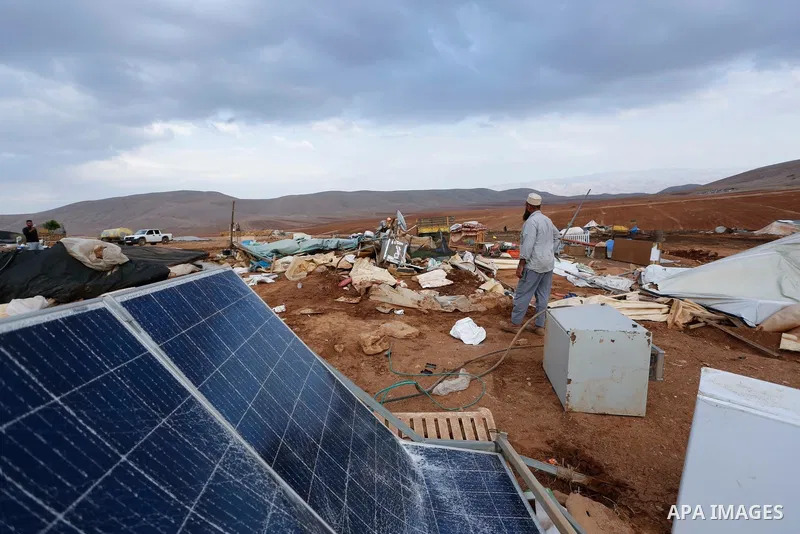 Palestinian bedouins stand next to their belongings after Israeli soldiers demolished their tents in an area east of the village of Tubas, in the West Bank, on November 3, 2020. Photo by Shadi Jarar'ah