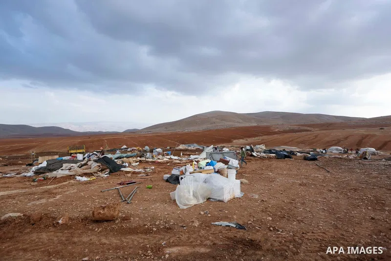 Palestinian bedouins stand next to their belongings after Israeli soldiers demolished their tents in an area east of the village of Tubas, in the West Bank, on November 3, 2020. Photo by Shadi Jarar'ah