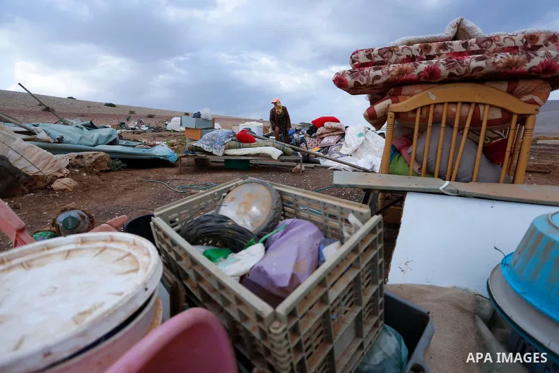 Palestinian bedouins stand next to their belongings after Israeli soldiers demolished their tents in an area east of the village of Tubas, in the West Bank, on November 3, 2020. Photo by Shadi Jarar'ah