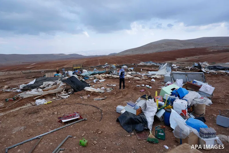 Palestinian bedouins stand next to their belongings after Israeli soldiers demolished their tents in an area east of the village of Tubas, in the West Bank, on November 3, 2020. Photo by Shadi Jarar'ah