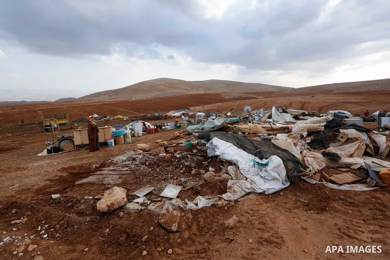 Palestinian bedouins stand next to their belongings after Israeli soldiers demolished their tents in an area east of the village of Tubas, in the West Bank, on November 3, 2020. Photo by Shadi Jarar'ah