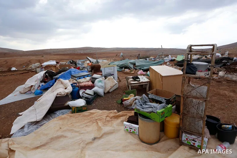 Palestinian bedouins stand next to their belongings after Israeli soldiers demolished their tents in an area east of the village of Tubas, in the West Bank, on November 3, 2020. Photo by Shadi Jarar'ah