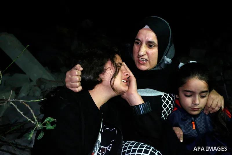 Palestinians sit over the rubble of a house demolished by the Israeli army in the West Bank city of Nanlus, November 2, 2020. The Israeli military says it has demolished the house of prisoner Khalil Dweikat who carried o...