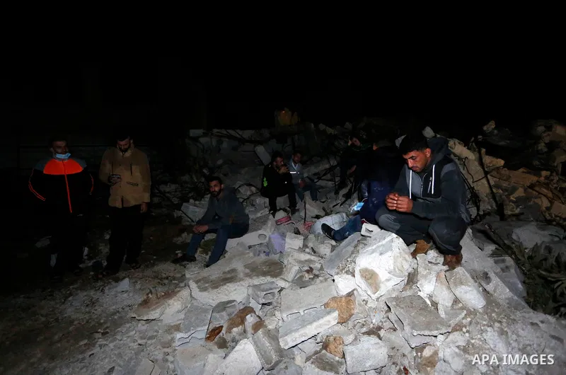 Palestinians sit over the rubble of a house demolished by the Israeli army in the West Bank city of Nanlus, November 2, 2020. The Israeli military says it has demolished the house of prisoner Khalil Dweikat who carried o...
