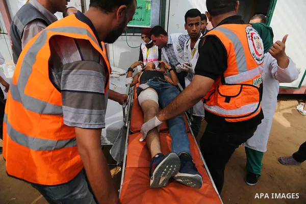 Injured Palestinian protestors receive treatment at a medical tent during clashes with Israeli security forces in tents protest where Palestinian demand the right to return to their homeland at the Israel-Gaza border, in...