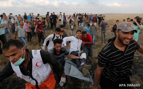A wounded Palestinian protester is evacuated during clashes with Israeli security froces in a tent city protest where Palestinians demand the right to return to their homeland and against U.S. embassy move to Jerusalem a...