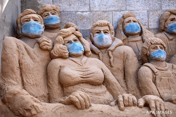 A Palestinian artist Rana el-Ramlawi, 23, creates a sand sculpture " stay home" during awareness campaign about the spread of coronavirus disease (COVID-19), at her house Gaza city, on April 3, 2020. The United Nations h...