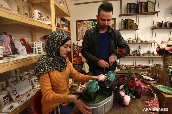 A Palestinian artist Dima Sha'sha'a "owner of Tezzkar Project" works at her shop in Gaza city on February 28, 2018. Dima and her brother Hamdi take the drawing on dishes, cardboard and glass as a job for nearly seven yea...