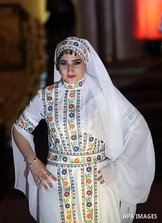 A picture taken on April 15, 2017 shows a Palestinian model displays a traditional Palestinian dress during a fashion show during the 2nd Nablus Festival for Culture and Arts, in the West Bank city of Nablus. The interna...