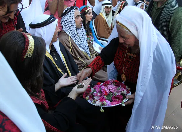 Palestinians take a part in a traditional wedding in the West Bank Town of Birzeit, near Ramallah during the Rozana Cultural Festival, June 26, 2013. Photo by Issam Rimawi
