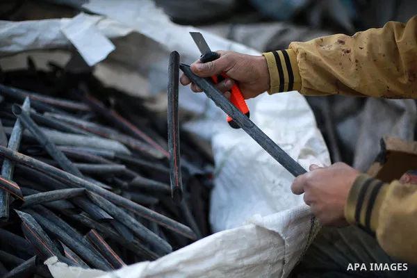 A Palestinian worker reuses plastics and metals to produce water hoses at a factory, in Gaza city, February 22, 2017. Workers collect the household recyclables, metals and plastic from landfill and garbage to sell to the...