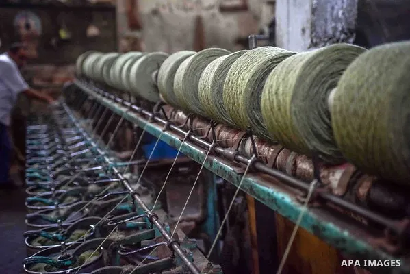 A worker prepares wool for production in a factory in Beheira Governorate, Egypt on September 3, 2016. Photo by Amr Sayed