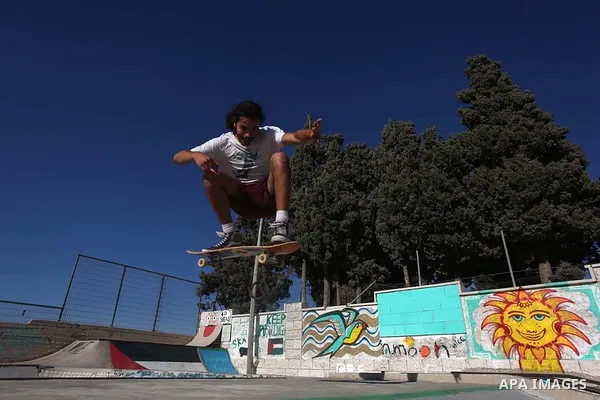 A foreign activist skateboards in a skatepark in the village of Asira ash-Shamaliya, near the West Bank city of Nablus, July 02, 2019. Skateboarding is an action sport which involves riding and performing tricks using a...