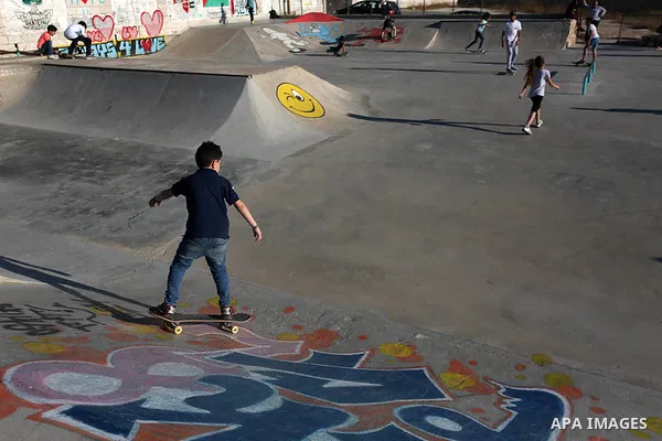 Palestinians and foreign activists skateboard in a skatepark in the village of Asira ash-Shamaliya, near the West Bank city of Nablus, July 02, 2019. Skateboarding is an action sport which involves riding and performing...