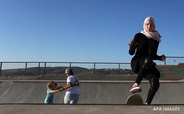 A Palestinian girl skateboards in a skatepark in the village of Asira ash-Shamaliya, near the West Bank city of Nablus, July 02, 2019. Skateboarding is an action sport which involves riding and performing tricks using a...