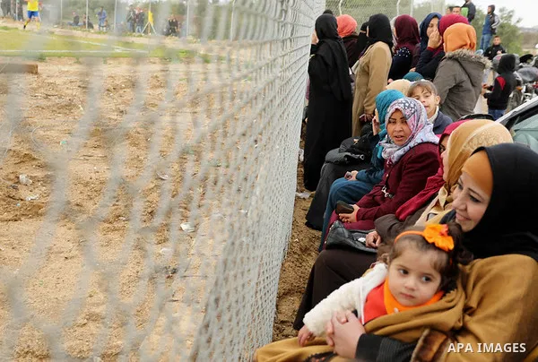 Palestinian women watch the football match between Al-Nuseirat and Al-Jalaa standing outside the fence of the stadium, at Nuseirat refugee camp, in the central of Gaza Strip, on January 28, 2018. Palestinian police allow...