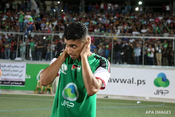 A Gaza Strip's Shejaiya's player reacts after losetheir return leg football match for the Palestine Cup final against Hebron's Al-Ahly's club at Hussein Bin Ali Stadium in the West Bank city of Hebron on August 14, 2015....