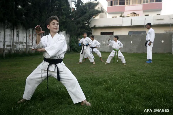 Palestinian boys take part in a karate class, which aims at teaching self-defense techniques during the summer holidays, at sport club in Gaza City on June 29, 2013. Photo by Emad Nassar