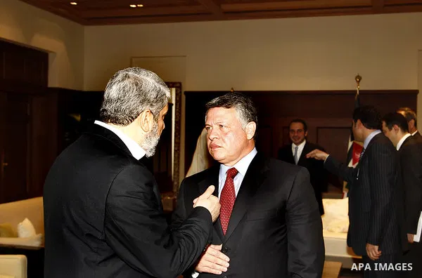 Jordan's King Abdullah (R) chats with senior Hamas leader Khaled Meshaal on his arrival at the Royal Palace in Amman January 29, 2012. Meshaal on Sunday made his first official visit to Jordan since the kingdom expelled...