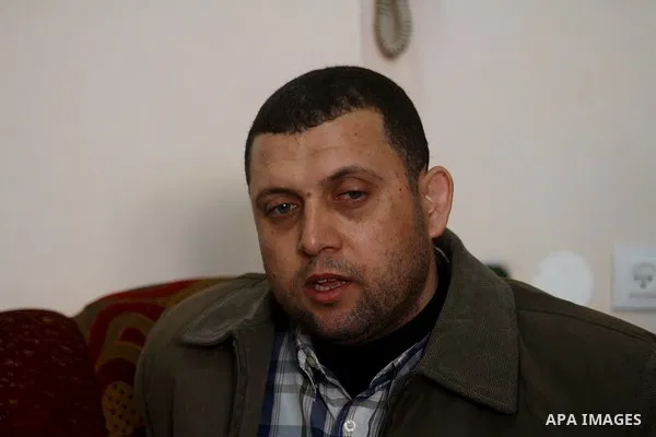 Ayman Nofal (C), a top Hamas armed commander, sits with his family (not seen) at his home in Nusairat in the Central Gaza strip on February 6, 2011. A senior Hamas commander returned to the Gaza Strip on Saturday after b...