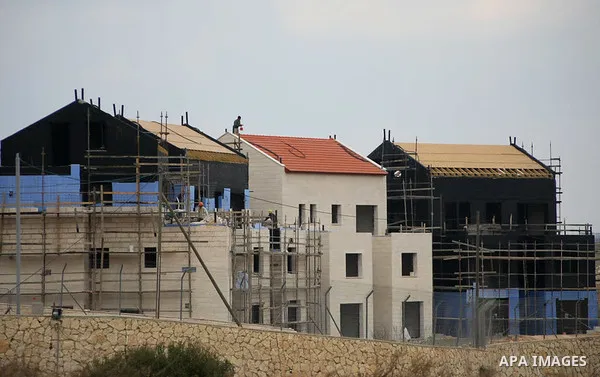 Construction laborers work at the site of a new housing unit in the Settlement of Vrata, southern the West Bank City of Bethlehem, Feb. 06, 2014. Israeli officials have given final approval for 558 new apartments in Jewi...