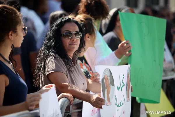 Palestinians hold signs and posters depicting Palestinian teen Mohammed Abu Khudair during a protest outside Jerusalem District Court August 6, 2014. Jerusalem District Court on Wednesday remanded Yosef Ben David, one of...