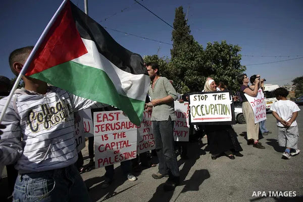 Palestinians and foreign activists take part in a rally as Israeli youths celebrating the Jerusalem Day in Jerusalem's Old City, Wednesday, May 12, 2010. Jerusalem Day marks Israel's capture of east Jerusalem and the reu...