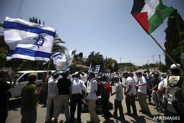 Israeli youths wave Israeli flags during a march celebrating Jerusalem Day in Jerusalem's Old City, Wednesday, May 12, 2010. Jerusalem Day marks Israel's capture of east Jerusalem and the reunification of the city, which...