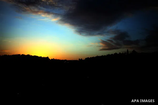A sunset is seen over Silwan neighborhood, in Jerusalem on December 26, 2013. Photo by Saeed Qaq
