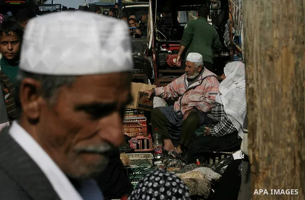 A Palestinian displays his birds for selling at the market in the Rafah refugee camp, southern Gaza Strip, on Dec. 07, 2013. Photo by Eyad Al Baba