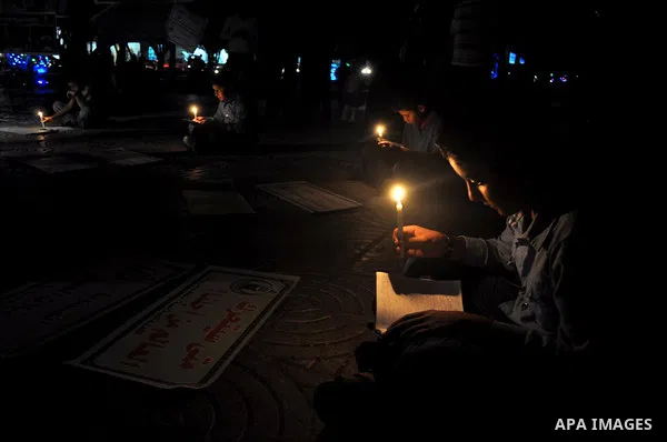 Palestinian school boys study on candles light during a protest against the severe fuel cuts that lead to power shortages and the siege in Gaza City on November 12, 2013. Gaza is left dependent on electricity purchased d...