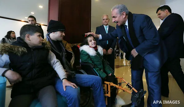 Palestinian Prime Minister Mohammad Ishtayeh, meets with children with cancer and cerebral palsy from the Gaza Strip, in the West Bank city of Ramallah, on January 14, 2020. Photo by Prime Minister Office