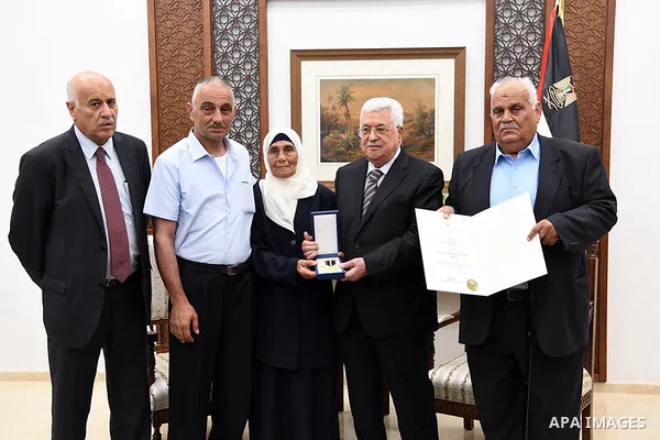 Palestinian President Mahmoud Abbas honors the families of martyrs in the West Bank city of Ramallah, on July 23, 2018. Photo by Thaer Ganaim