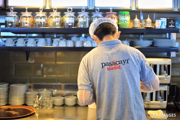 Turks, some wearing masks as a precaution against the spread of the coronavirus disease (COVID-19), sit in cafes, after the decision to open restaurants, cafes, cafeterias and public places in Istanbul, Turkey on June 3,...