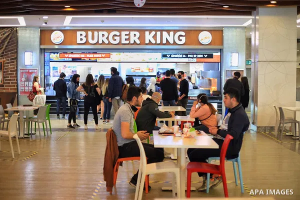 Turks, some wearing masks as a precaution against the spread of the coronavirus disease (COVID-19), sit in cafes, after the decision to open restaurants, cafes, cafeterias and public places in Istanbul, Turkey on June 3,...