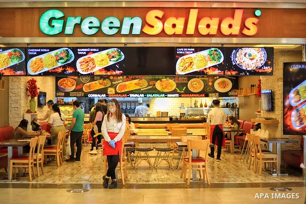 Turks, some wearing masks as a precaution against the spread of the coronavirus disease (COVID-19), sit in cafes, after the decision to open restaurants, cafes, cafeterias and public places in Istanbul, Turkey on June 3,...