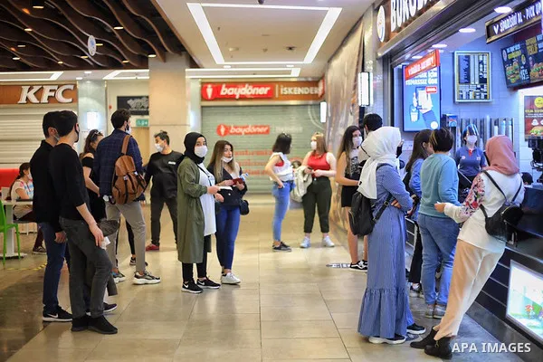 Turks, some wearing masks as a precaution against the spread of the coronavirus disease (COVID-19), sit in cafes, after the decision to open restaurants, cafes, cafeterias and public places in Istanbul, Turkey on June 3,...