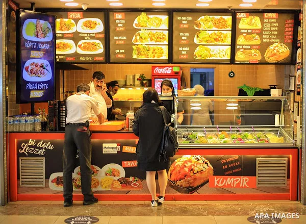 Turks, some wearing masks as a precaution against the spread of the coronavirus disease (COVID-19), sit in cafes, after the decision to open restaurants, cafes, cafeterias and public places in Istanbul, Turkey on June 3,...