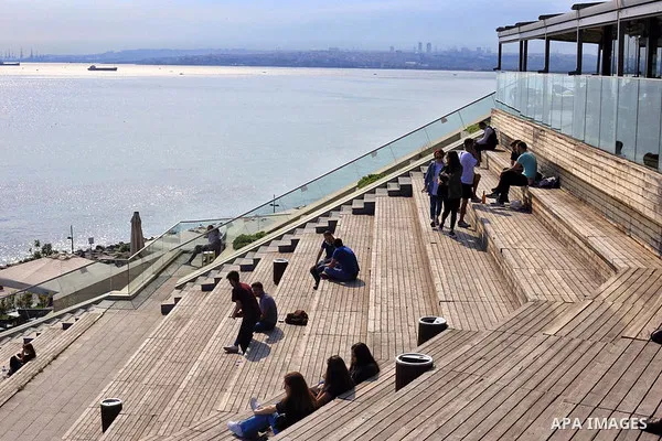 Turks, some wearing masks as a precaution against the spread of the coronavirus disease (COVID-19), sit in cafes, after the decision to open restaurants, cafes, cafeterias and public places in Istanbul, Turkey on June 3,...