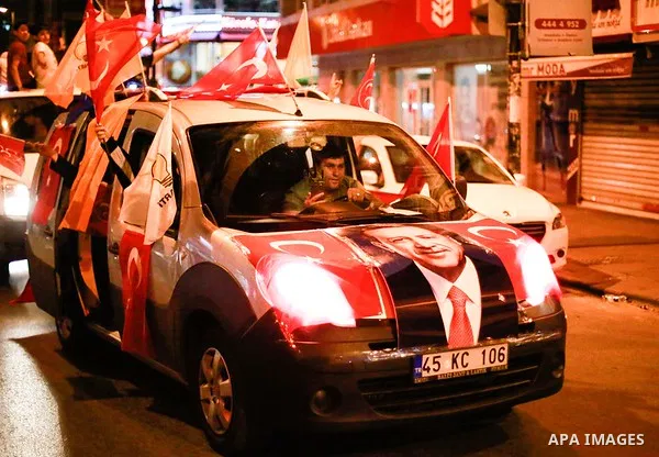 A picture taken on June 24, 2018 shows Supporters of Turkish President Recep Tayyip Erdogan celebrate the results of the Turkish presidential and parliamentary elections, in Istanbul, Turkey. Photo by Shady al-Assar