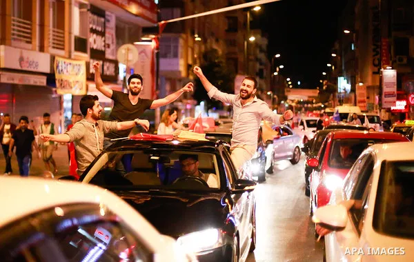 A picture taken on June 24, 2018 shows Supporters of Turkish President Recep Tayyip Erdogan celebrate the results of the Turkish presidential and parliamentary elections, in Istanbul, Turkey. Photo by Shady al-Assar