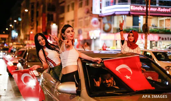 A picture taken on June 24, 2018 shows Supporters of Turkish President Recep Tayyip Erdogan celebrate the results of the Turkish presidential and parliamentary elections, in Istanbul, Turkey. Photo by Shady al-Assar