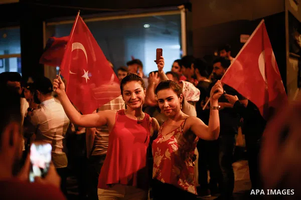 A picture taken on June 24, 2018 shows Supporters of Turkish President Recep Tayyip Erdogan celebrate the results of the Turkish presidential and parliamentary elections, in Istanbul, Turkey. Photo by Shady al-Assar