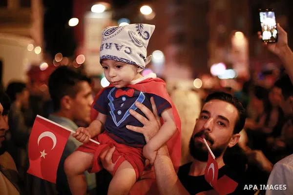 A picture taken on June 24, 2018 shows Supporters of Turkish President Recep Tayyip Erdogan celebrate the results of the Turkish presidential and parliamentary elections, in Istanbul, Turkey. Photo by Shady al-Assar