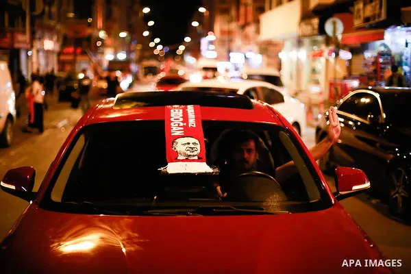 A picture taken on June 24, 2018 shows Supporters of Turkish President Recep Tayyip Erdogan celebrate the results of the Turkish presidential and parliamentary elections, in Istanbul, Turkey. Photo by Shady al-Assar